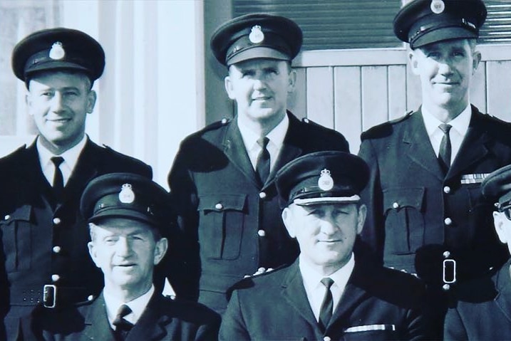 Men in police uniform stand for group photo