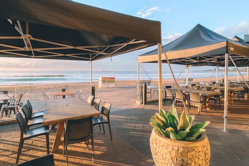 Chairs and tables outside a cafe on the beach