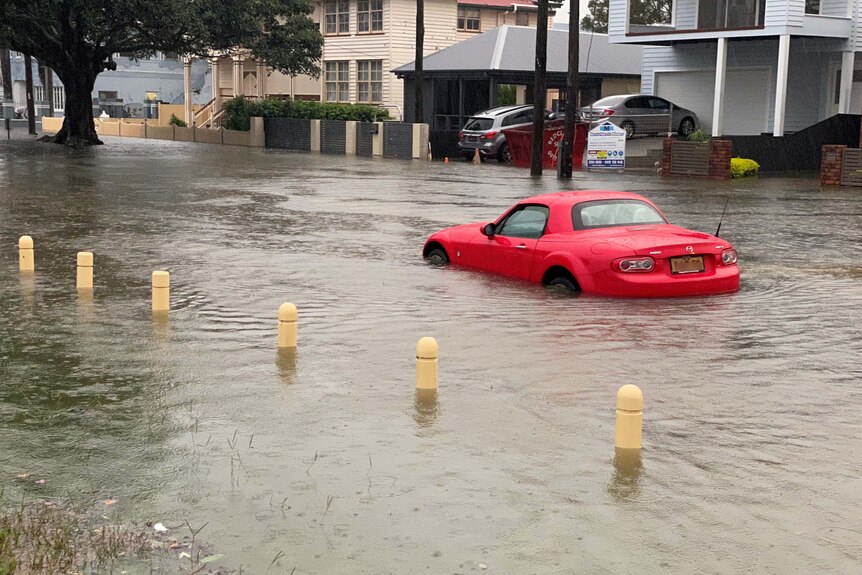 Sports car in flooded street in Brighton, in Brisbane's north