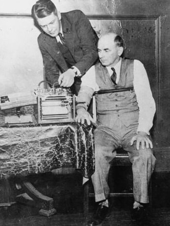 An archival photo shows a man in a suit operating a polygraph machine on a trial witness.