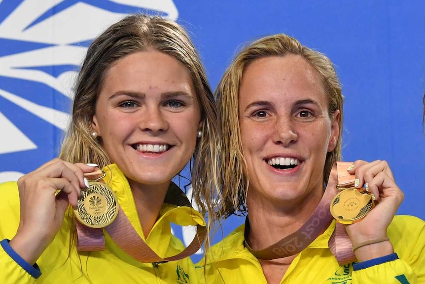 The Australian women's relay team holds their gold medals on the podium
