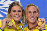 The Australian women's relay team holds their gold medals on the podium