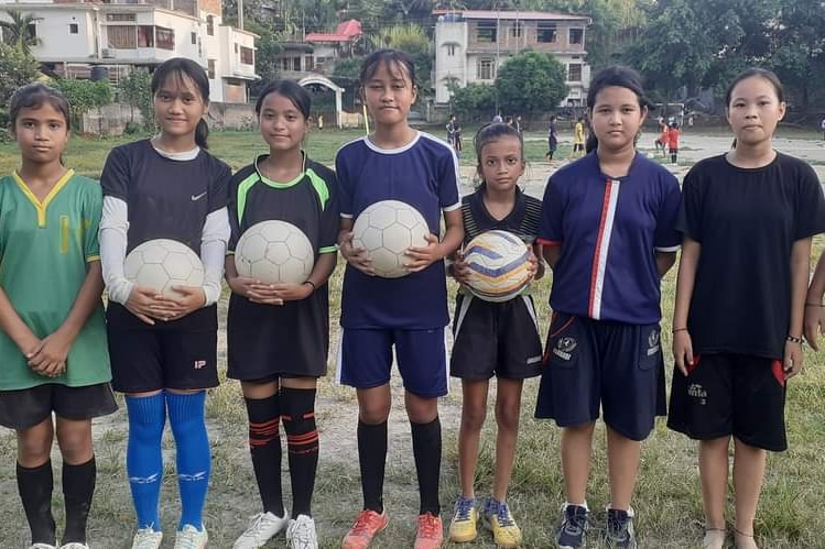 Girls stand in a line at training at Rainbow Football Academy in India.