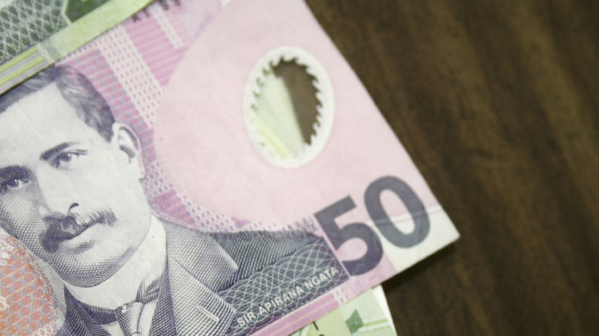 New Zealand bank notes spread out on a table.