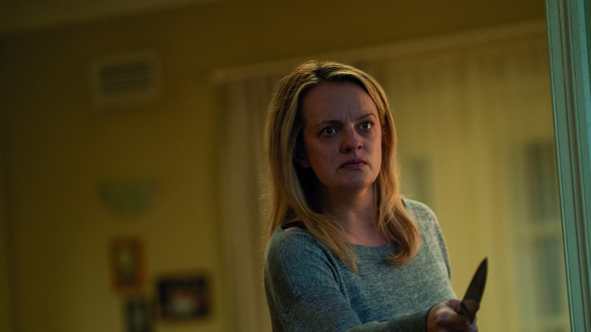 Elisabeth Moss, appearing distressed, holds a knife