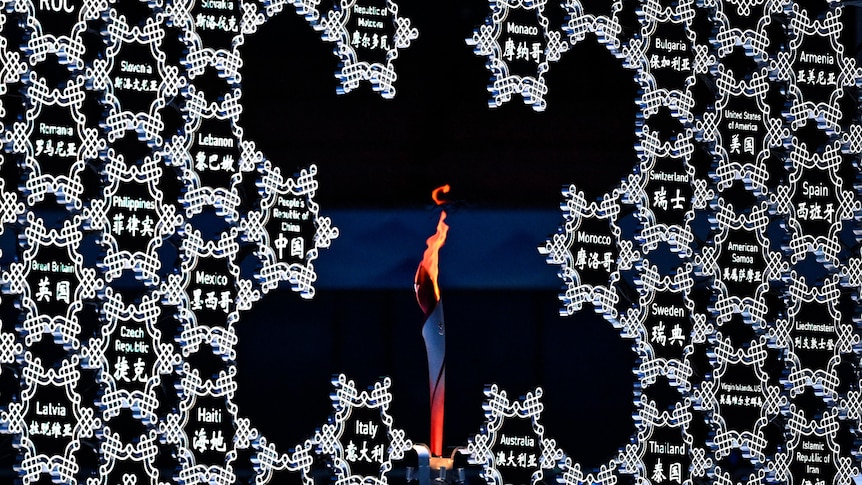 The Olympic flame is seen in the middle of a giant snowflake during the opening ceremony. 