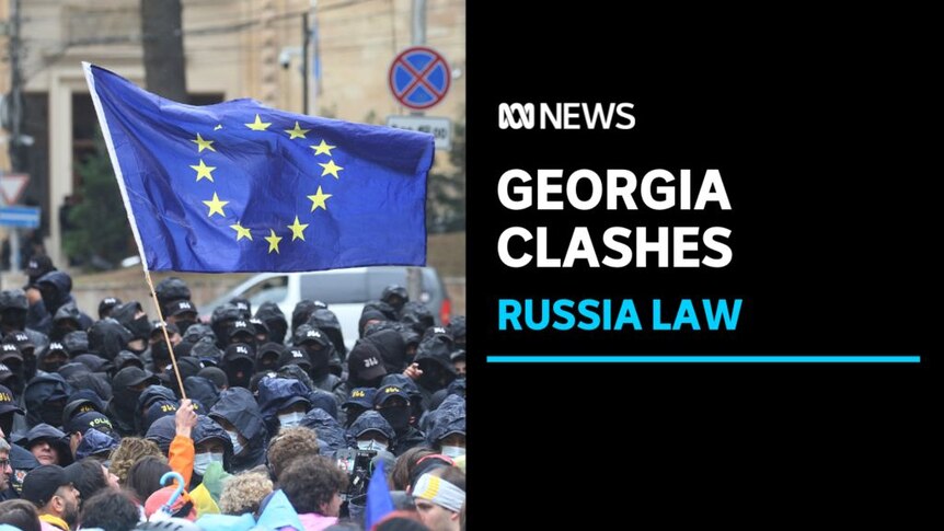 Georgia Clashes, Russia Law: An EU flag is waved as protesters face off with police during protests.