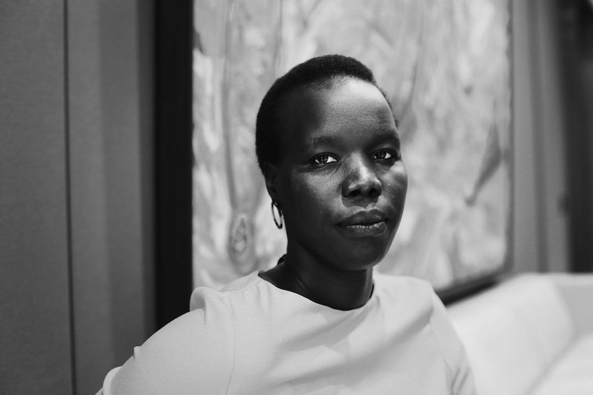 Short haired African woman looking at calendar