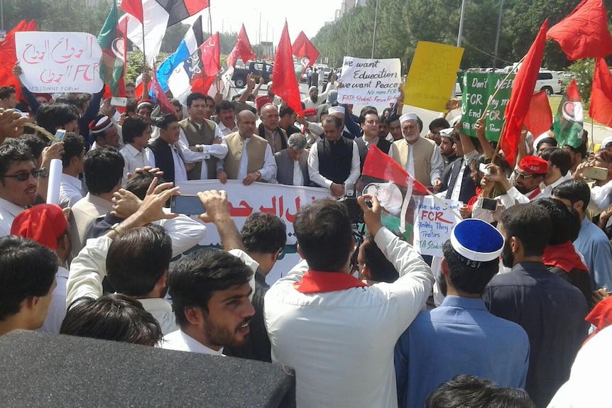 FATA Lawyers Forum lead a protest waving banners, holding flags, to press for early implementation of FATA reforms.
