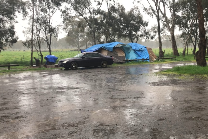 a tent sits wet in the rain