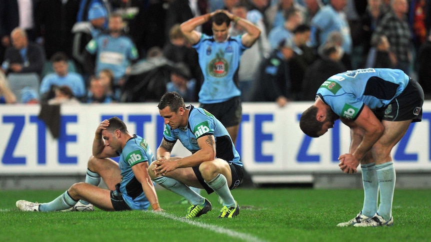 Dejected NSW Blues players react after losing State of Origin III