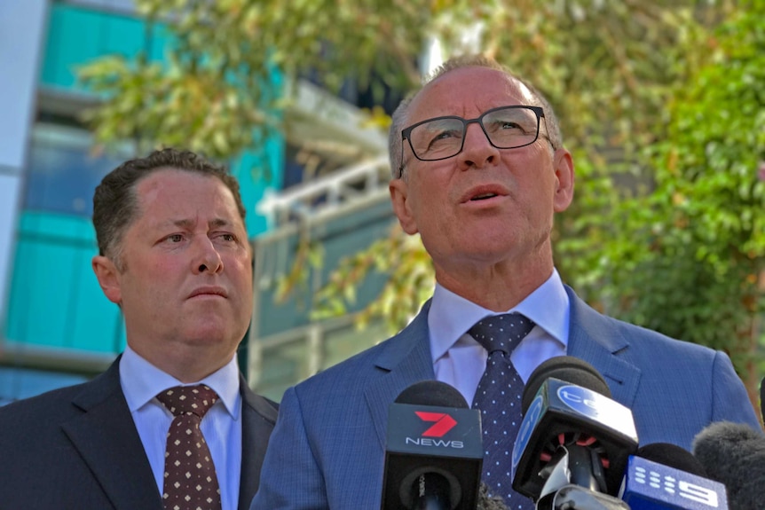 Jack Snelling and Jay Weatherill at a news conference outdoors.