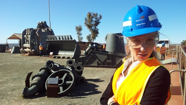 Veronica Macpherson in Newman wearing a blue hard hat and high-visibility orange vest.