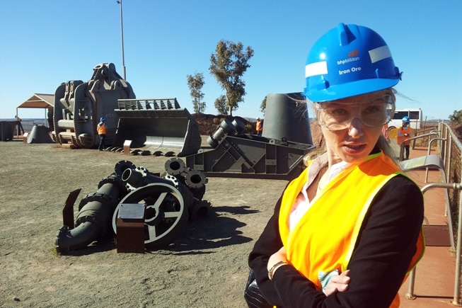 Veronica Macpherson in Newman wearing a blue hard hat and high-visibility orange vest.