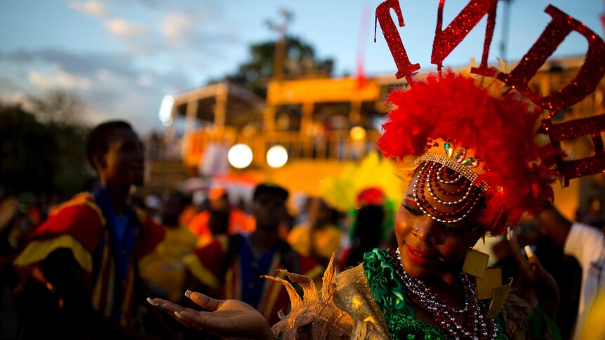 A dancer in a colourful costume and headdress performs during a Carnival parade in Port-au-Prince, Haiti.