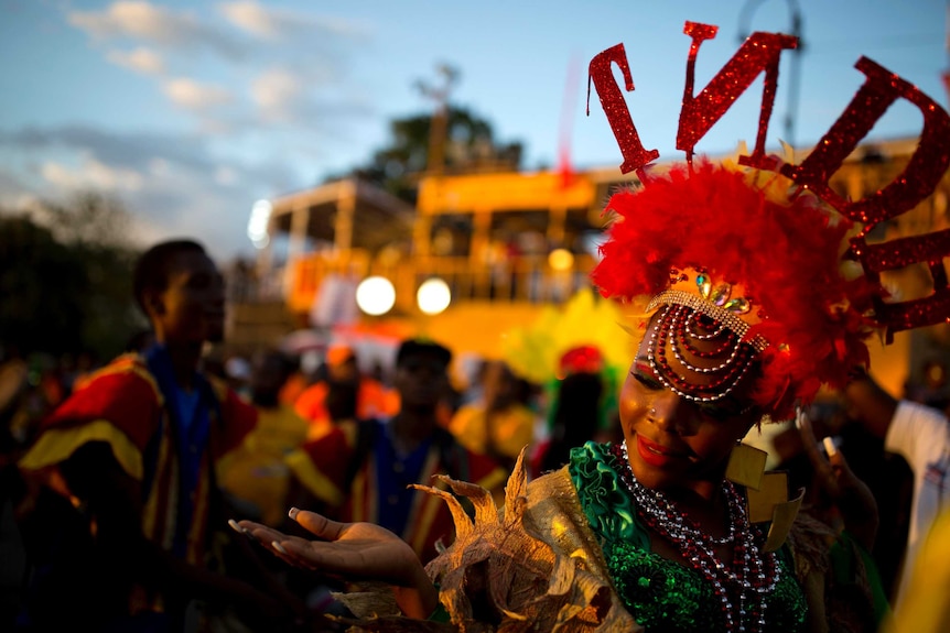 A dancer in a colourful costume and headdress performs during a Carnival parade in Port-au-Prince, Haiti.