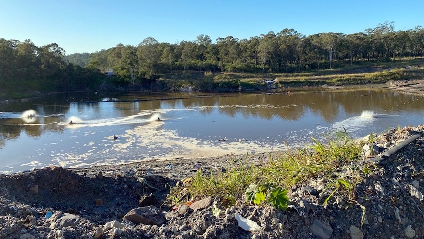 A pool of stagnant water at a landfill site.