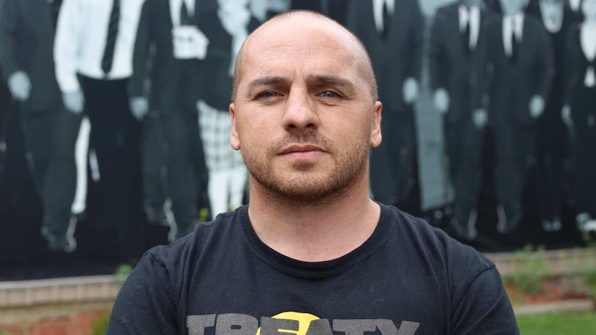 A man looks at the camera with a T-shirt reading: "Treaty for Victoria".