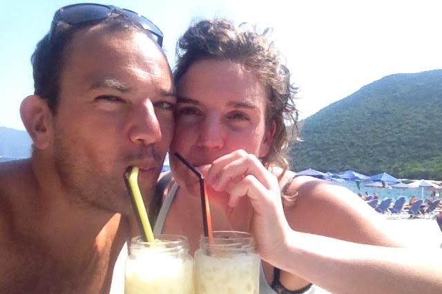 Emma Bleaney and her brother Daniel are sitting on a beach sipping iced drinks.