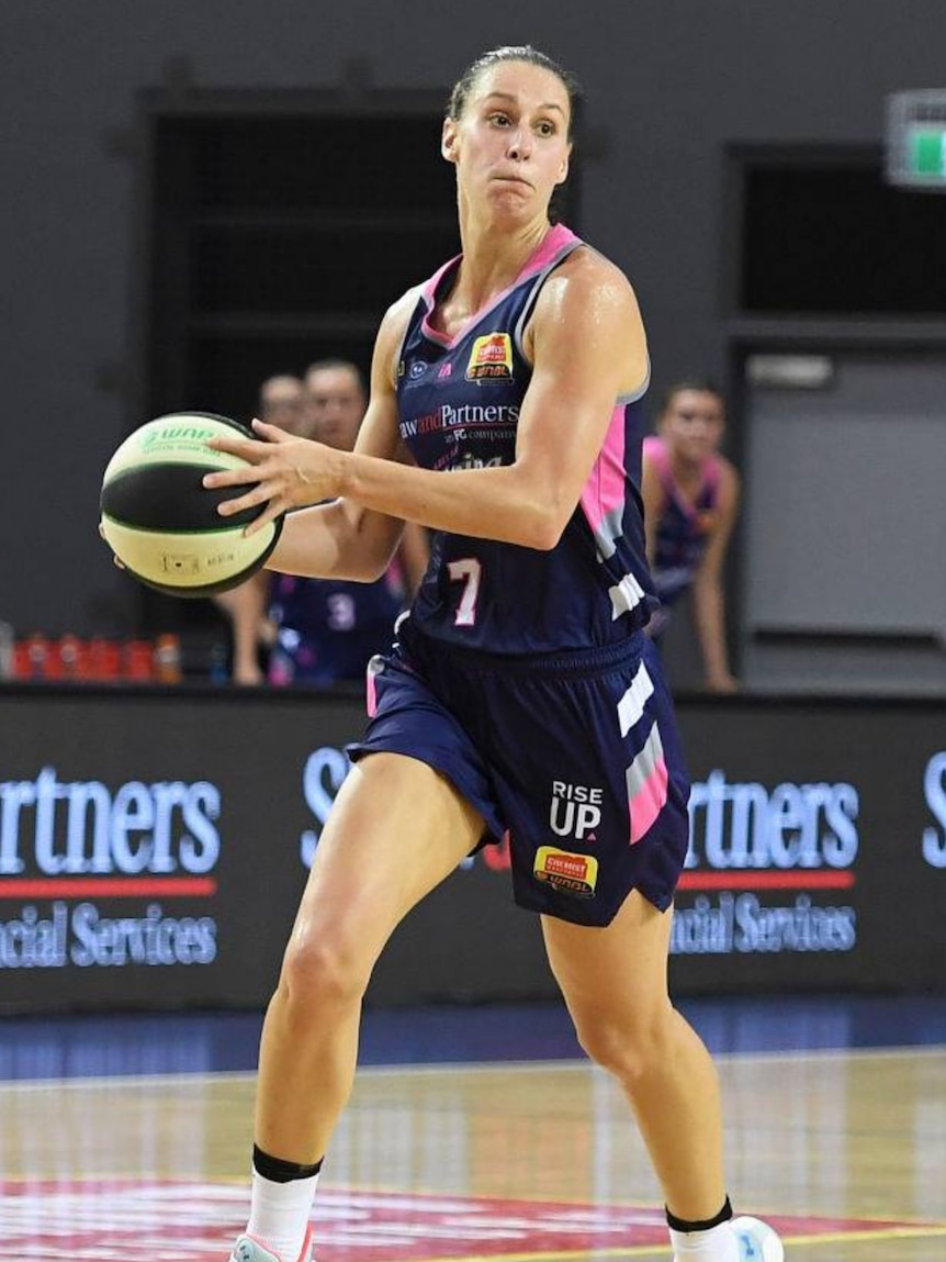 Steph Talbot prepares to throw the ball while on the basketball court.
