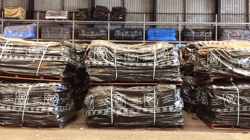 Stacks of cattle hides wrapped up in plastic packaging.