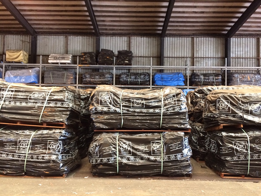 Stacks of cattle hides wrapped up in plastic packaging.