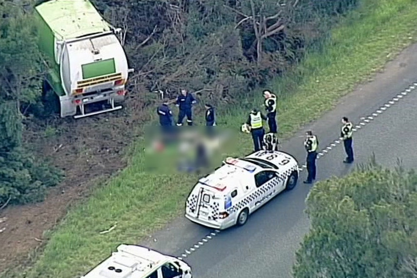 Emergency services gather around the body of a cyclist who died after being hit by a garbage truck in Moorooduc.