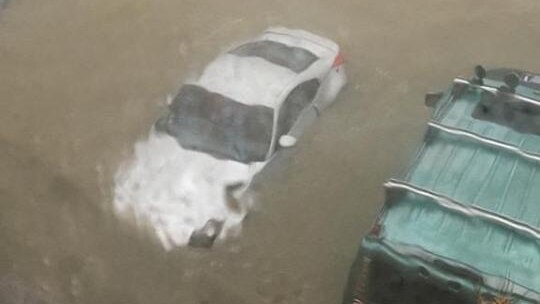 Cars are submerged by deep water on what should be dry land.