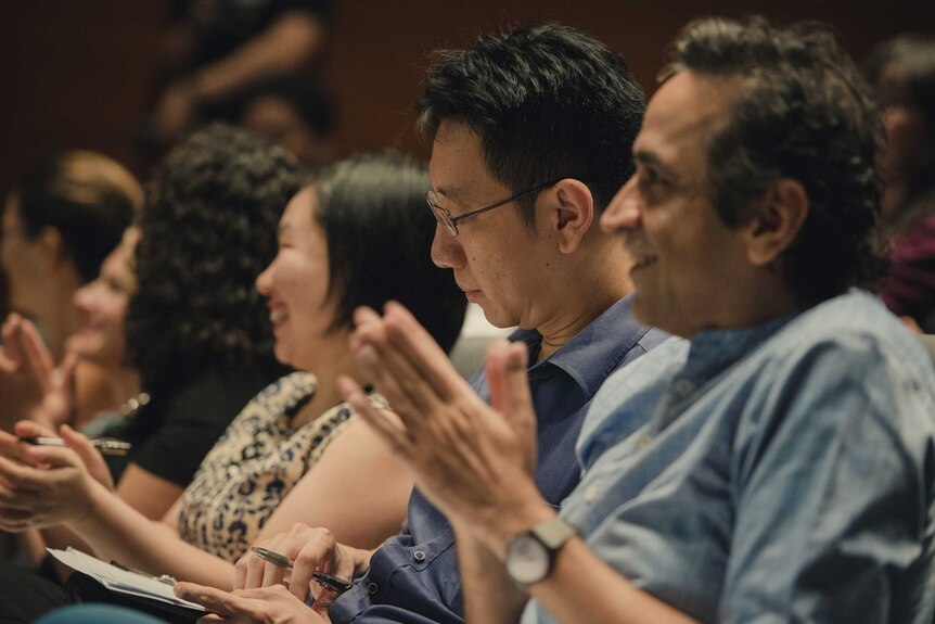 Judges Yu Yan Chen, Alvin Pang and Haresh Sharma applaud during the competition