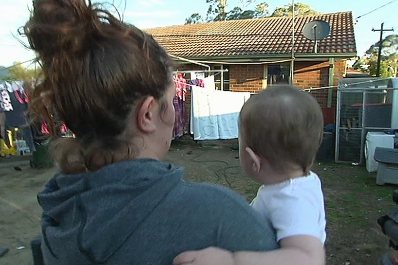 A woman holding a baby.