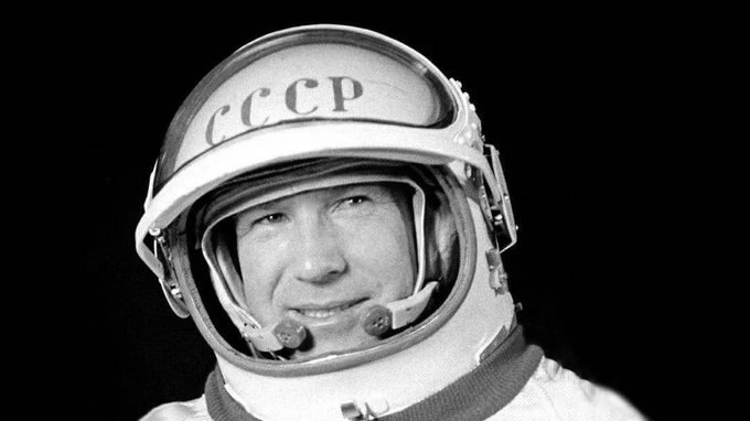 A black and white image of a man in a space suit.