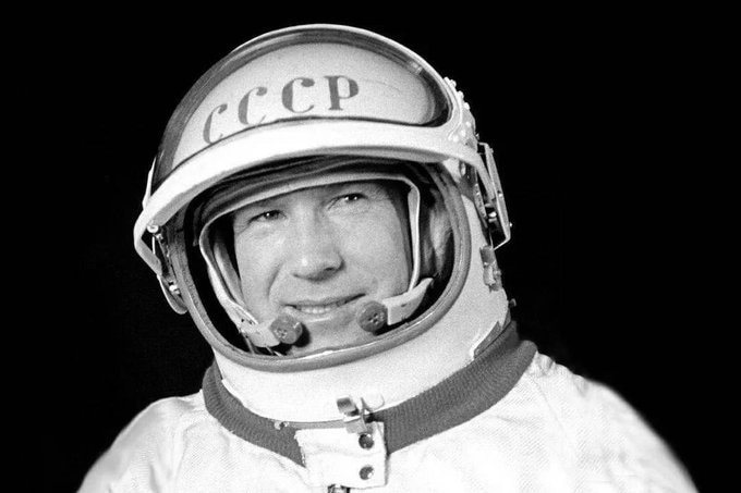 A black and white image of a man in a space suit.
