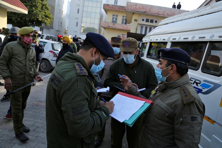 Police officers take down the details of the victims outside hospital.