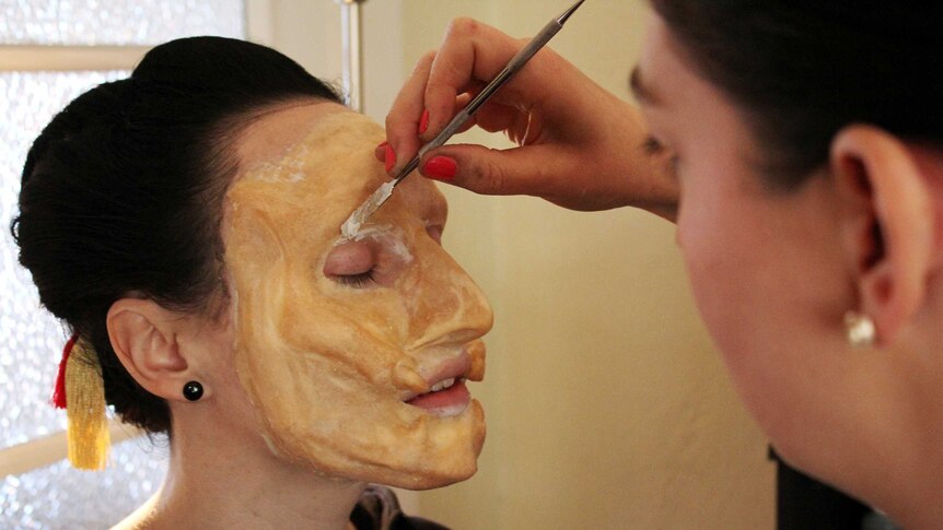 Mel Cooper applying makeup to her model during a rehearsal for the competition in New Zealand.