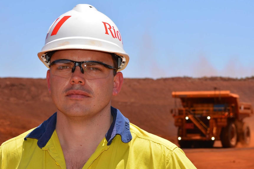 Rio Tinto Pilbara mine operations manager Josh Bennett with a driverless truck 18 October 2015.