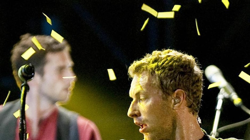 Coldplay, with Chris Martin in front, performs onstage