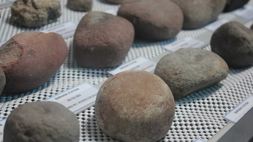 Collection of round rocks under glass