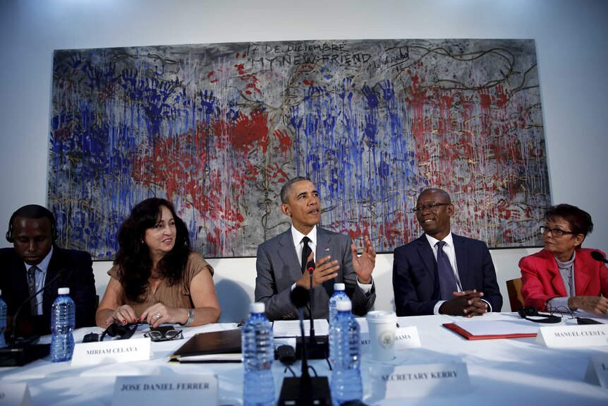 Barack Obama sits at a table with a group of Cuban dissidents.