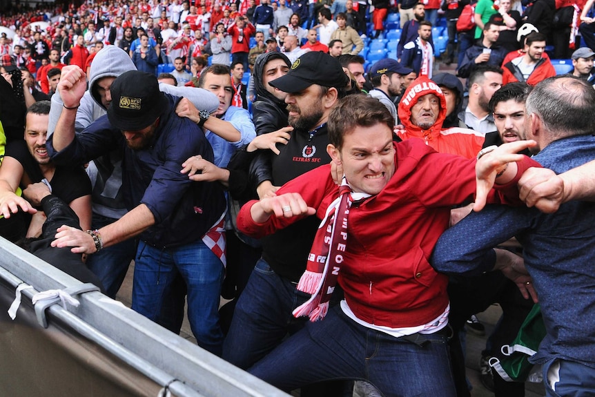 Sevilla fans brawl with Liverpool supporters