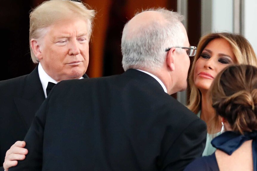 Prime Minister Scott Morrison goes into kiss first lady Melania Trump.