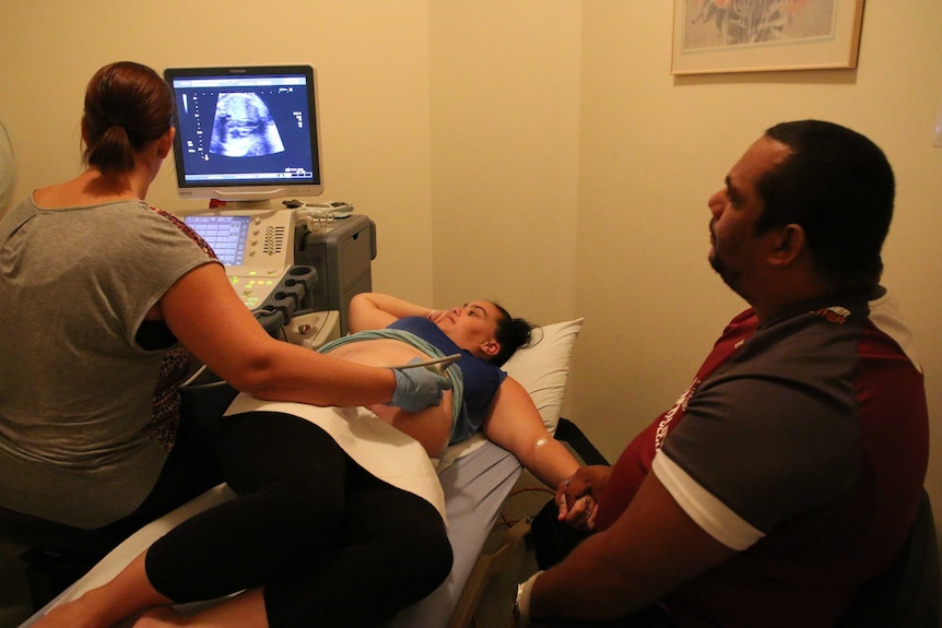 Indigenous research coordinator Loretta Weatherall conducts an ultrasound on a pregnant mother.