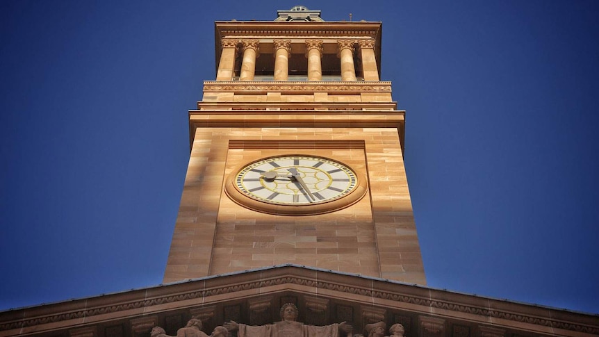 Brisbane City Hall clock tower looking up towards the sky.