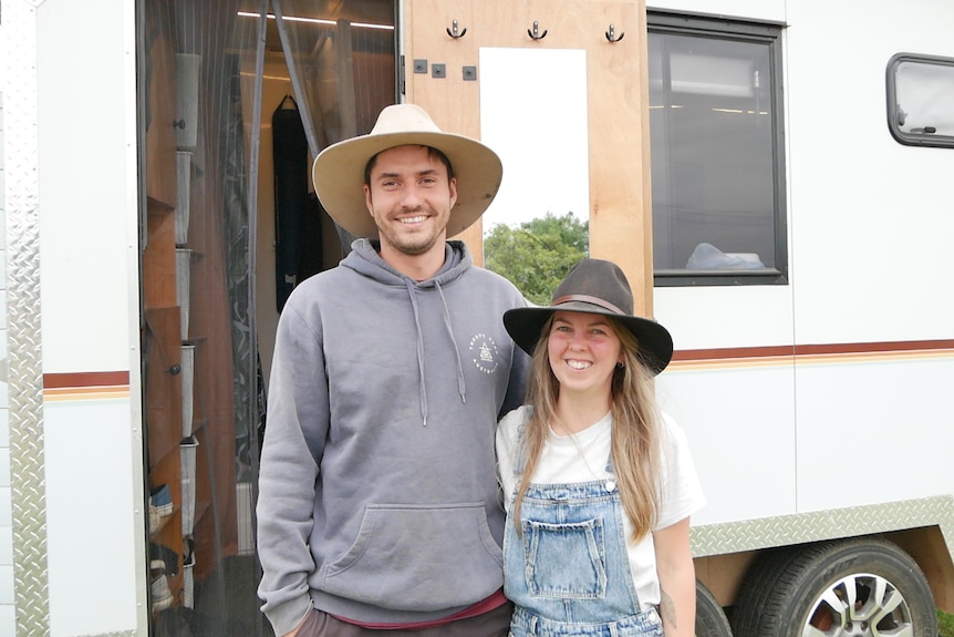 couple standing in front of van