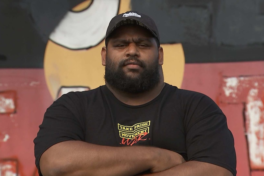 Brisbane Invasion Day March organiser Bo Spearim standing with his arms corssed.