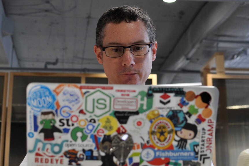 Josh Wulf behind a laptop