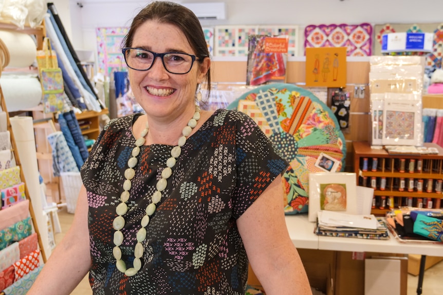 A woman stands in her sewing shop in Berry.