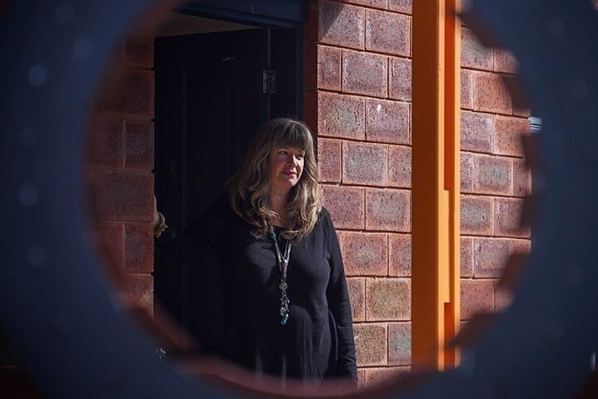 Kate the lifelong renter in front of brick wall, Tasmania, May 2019