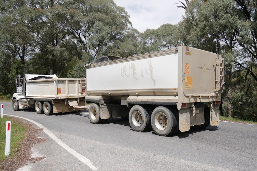 A truck driving on a regional road.