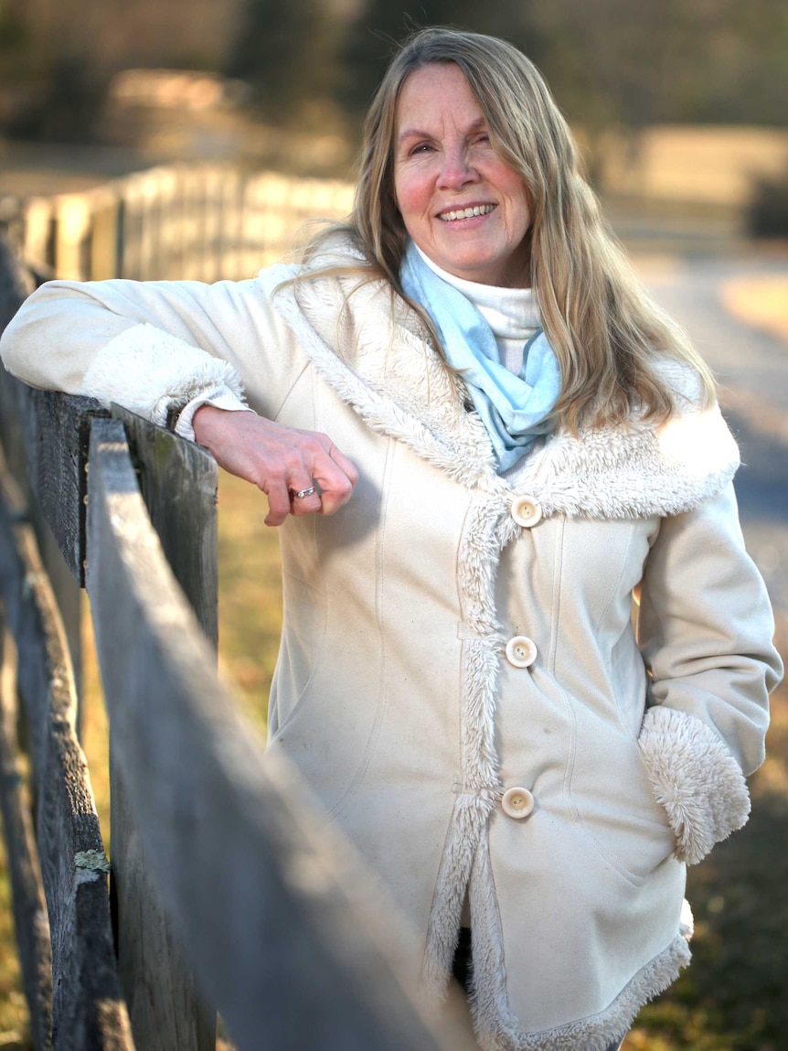 Democrat Wendy Gooditis standing near the fence of her farm in Virginia.