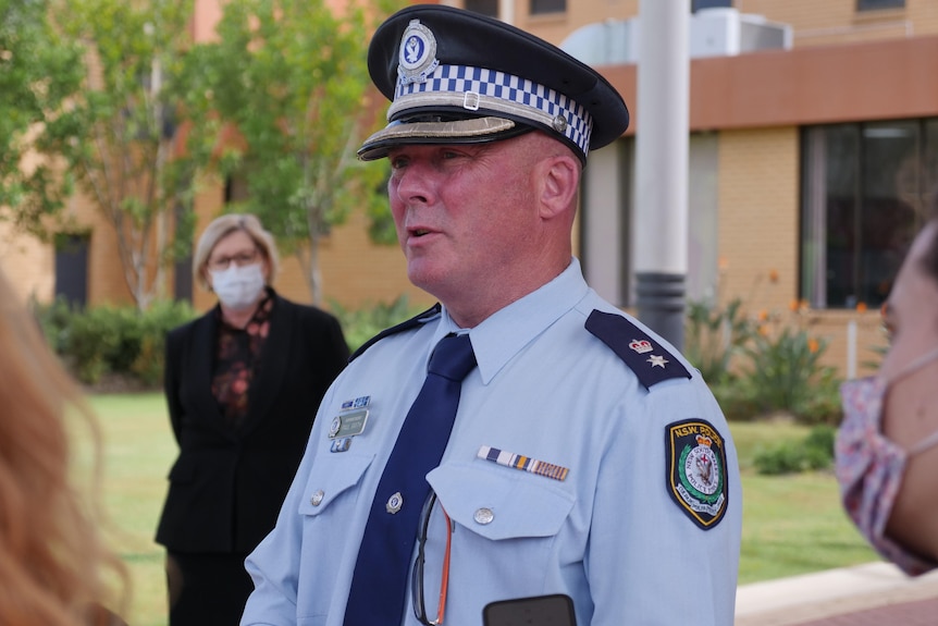 man in police uniform and hat